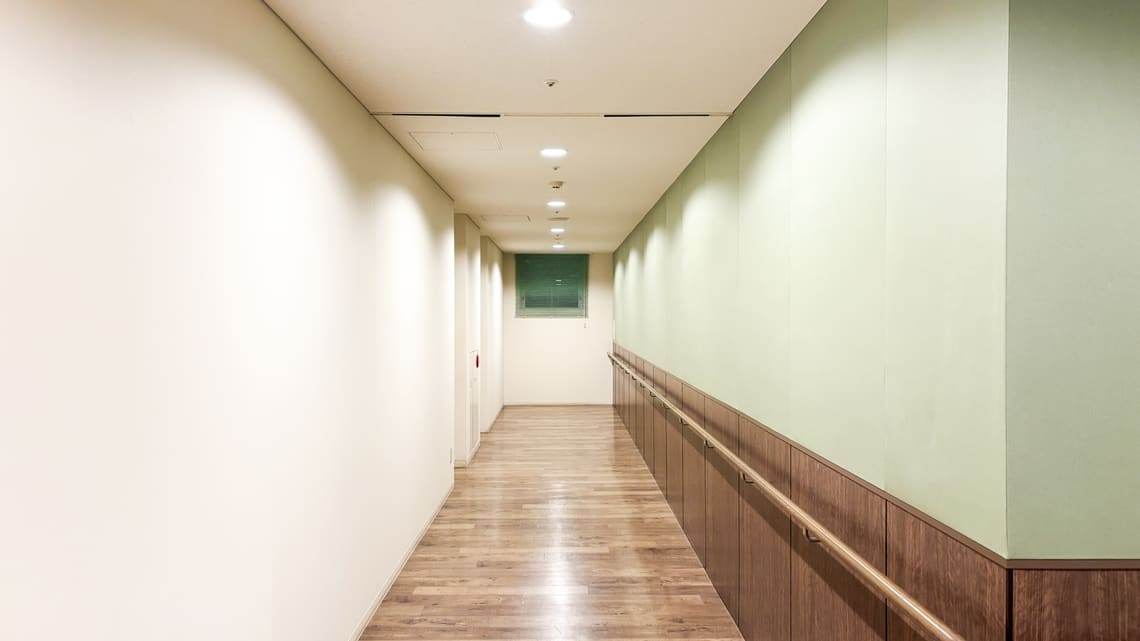 施設の廊下と木の手すりのイメージ